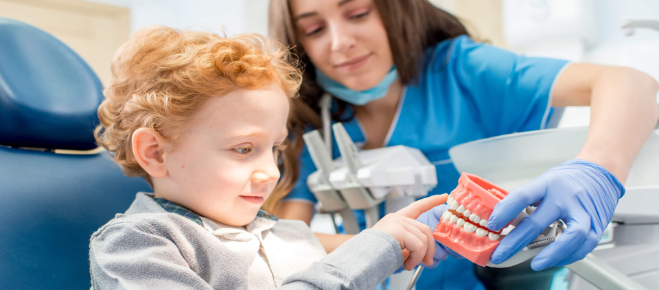 Child looking at mouth prop.